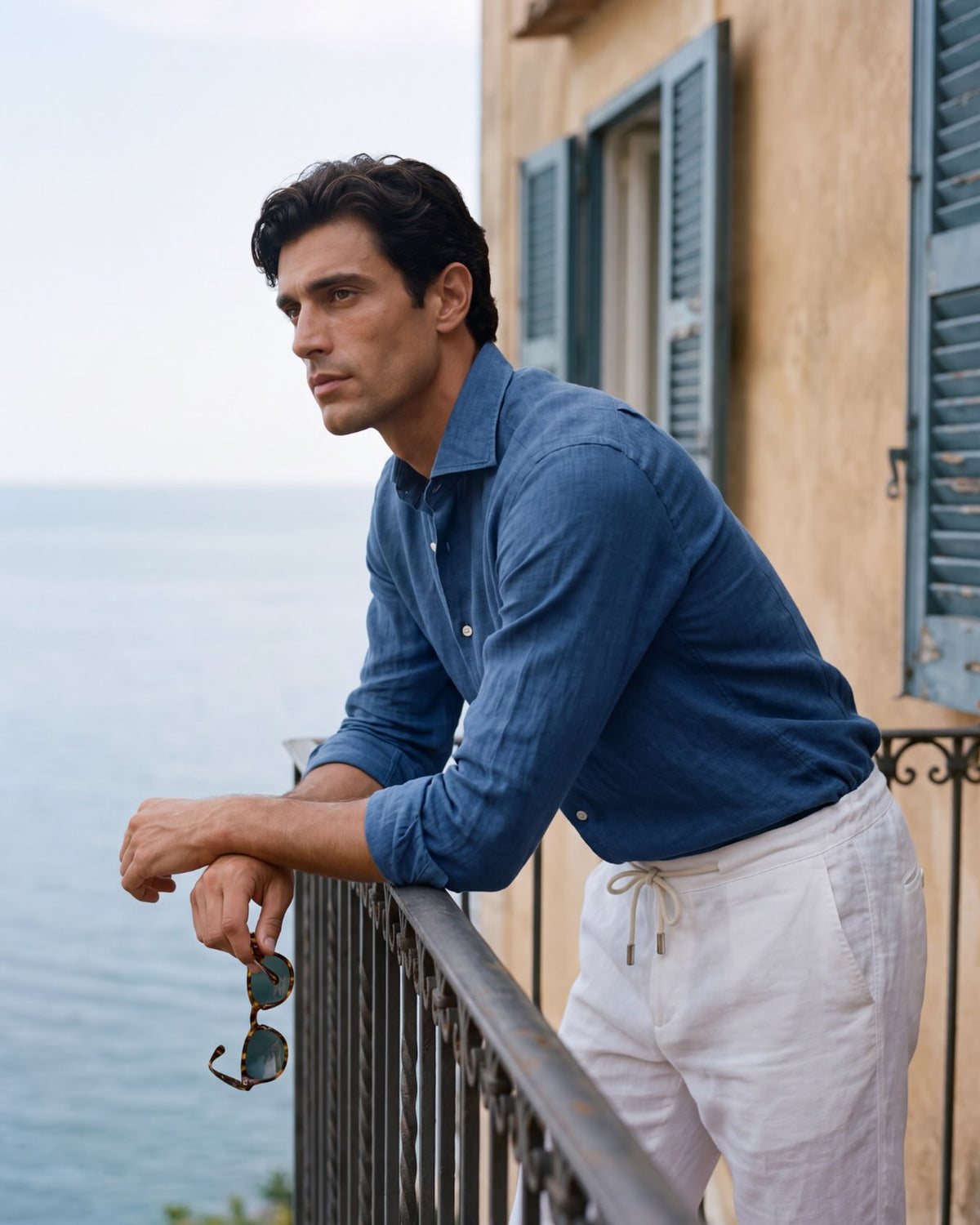 Man wearing a Santoli Napoli linen shirt on a balcony